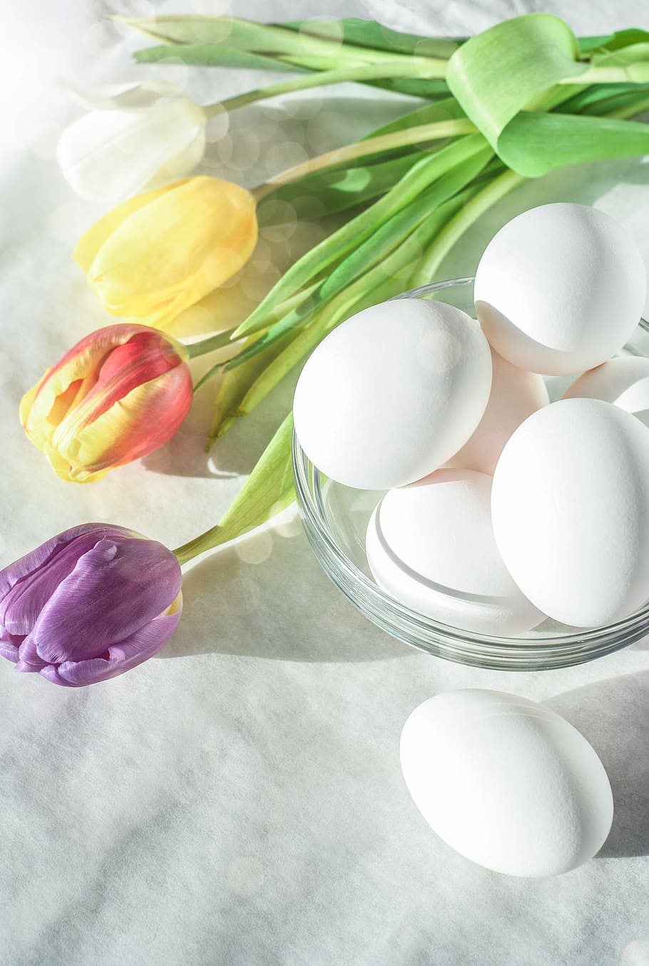 assorted-color petaled flowers and eggs on white textile, easter HD wallpaper