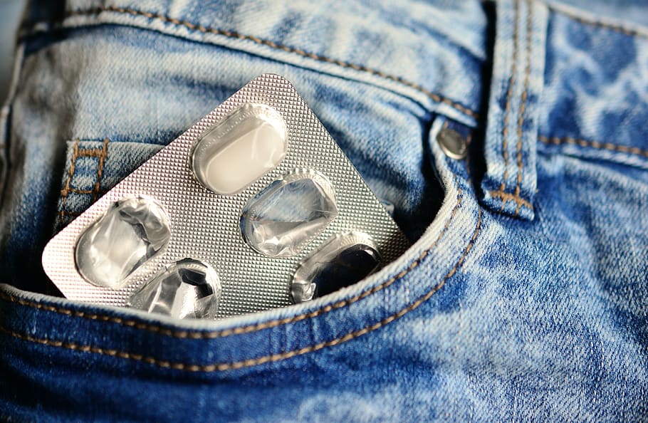 silver blister pack with one caplet left inside blue denim bottoms pocket HD wallpaper