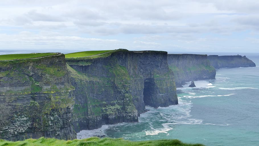 in distant photo of rock formation, cliffs of moher, ireland
