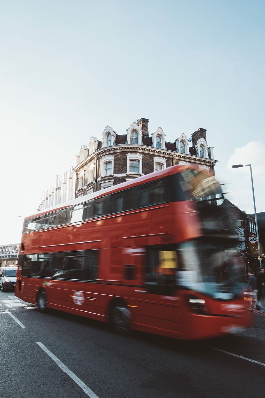 red double-deck bus travelling near near brown and white building during daytime, photo of double-deck bus near brown building during daytime HD wallpaper