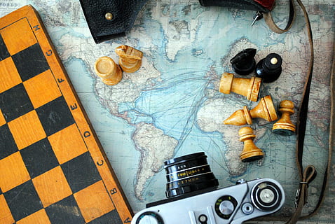 SLR camera near chess board, world map, indoors, no people HD wallpaper