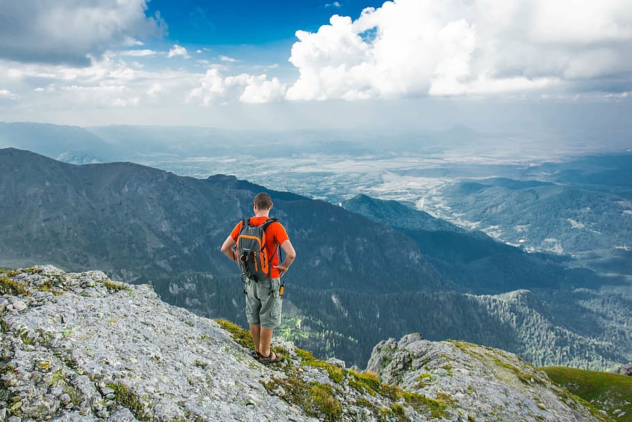 man standing on cliff facing mountain, valley, landscape, nature HD wallpaper
