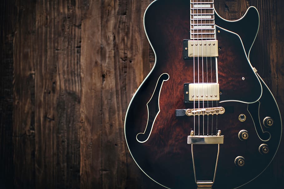 black and brown electric guitar on brown wooden surface, music, HD wallpaper