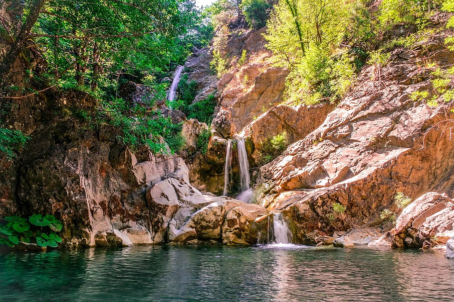 landscape photography of waterfall between forest trees, pond HD wallpaper