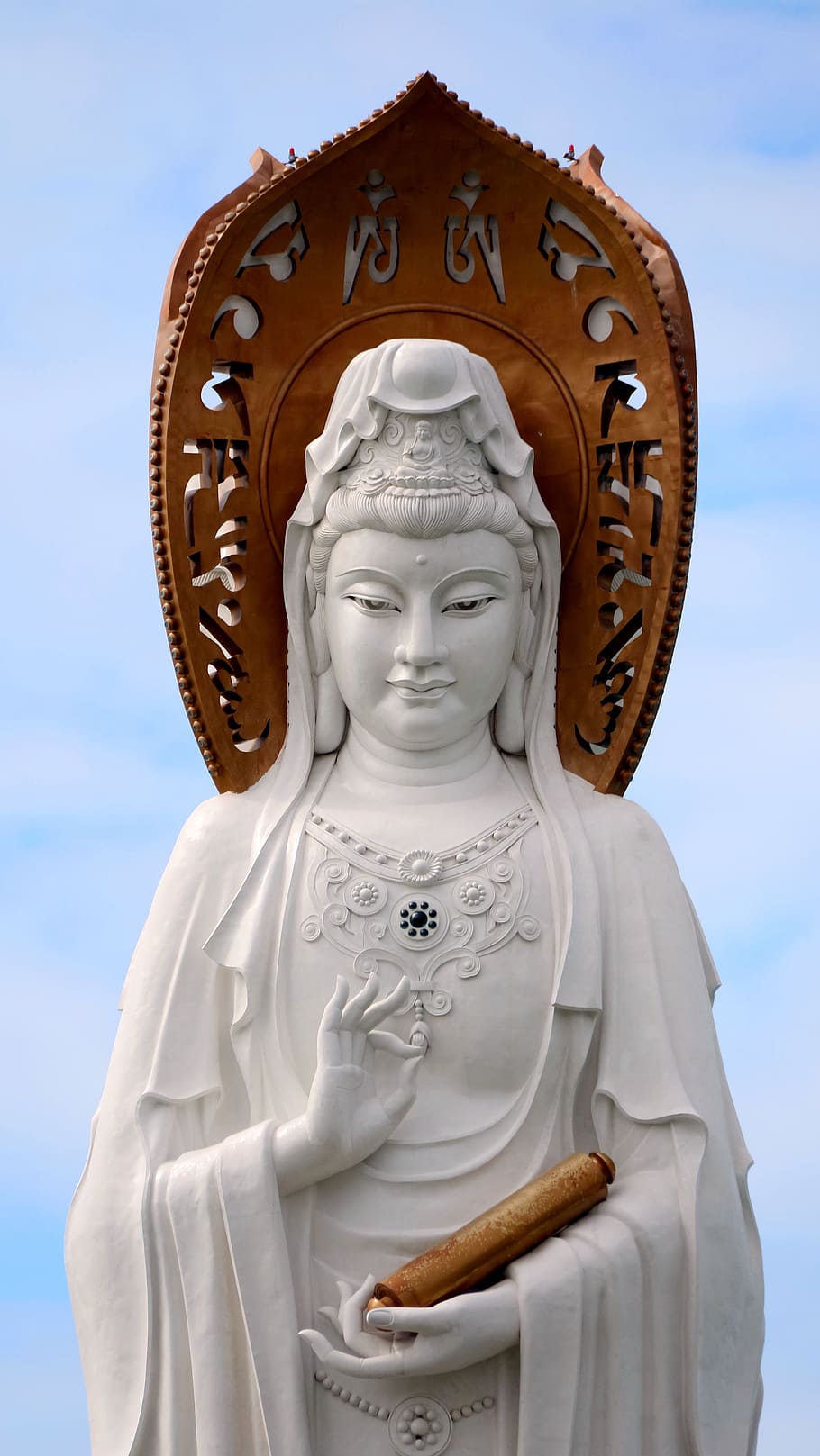 white and brown statue of woman under white sky, Hainan Island