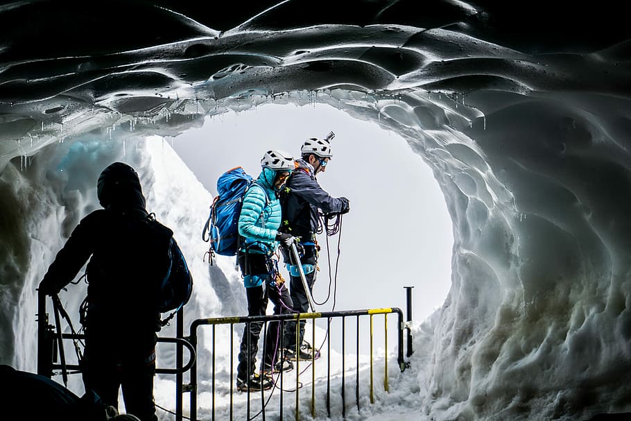people walking on ice covered cave, two person wearing harness surrounded by snow HD wallpaper