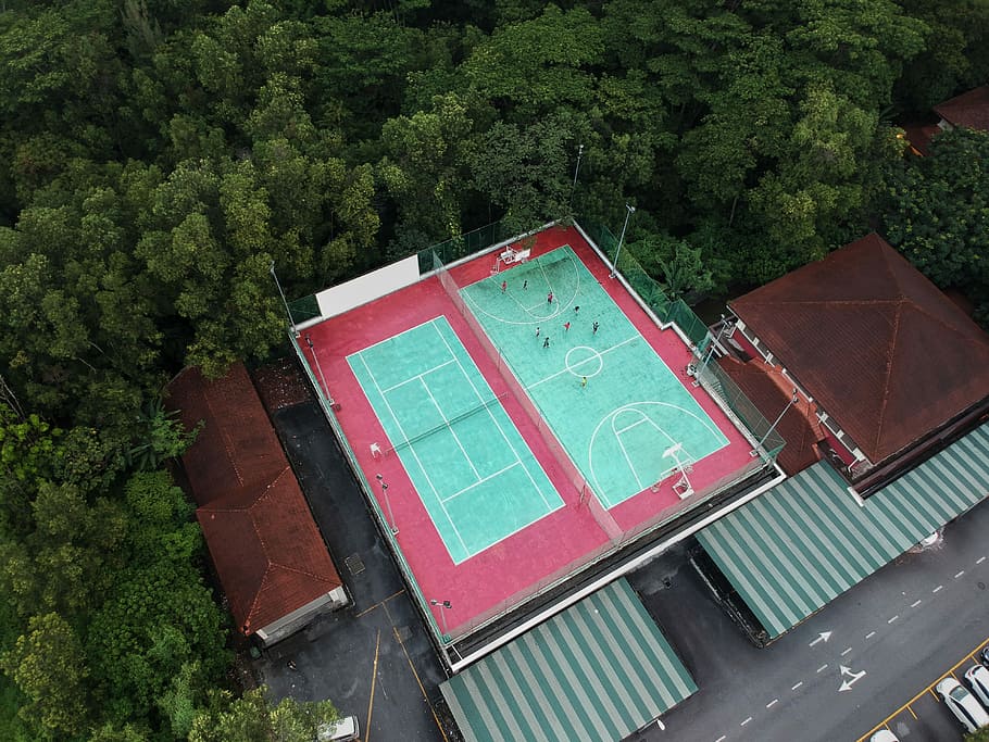 aerial photography of tennis and basketball courts, bird's-eye view photo of brown house