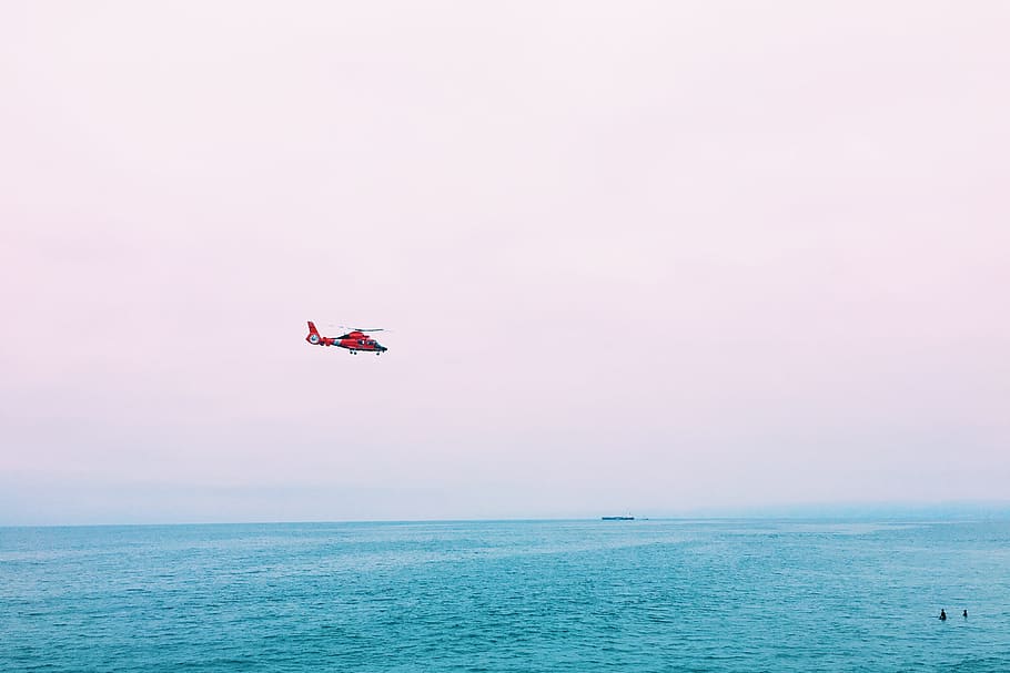 red plane on mid air above sea, flying helicopter above body of water at daytime, HD wallpaper