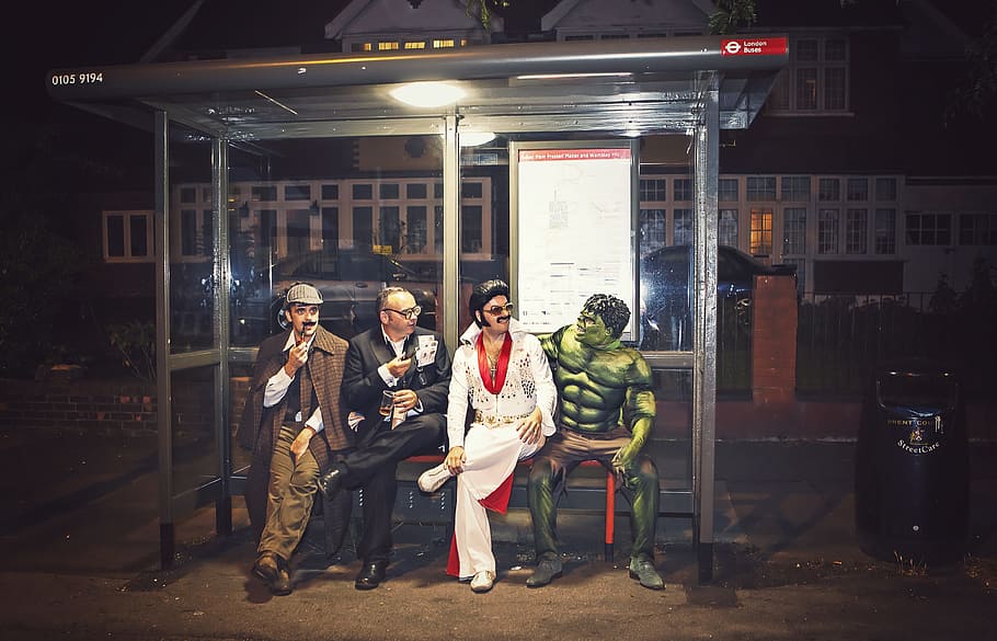 four men's seating on gray metal bench chair, superhero, sherlock HD wallpaper