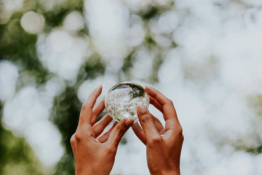 Woman with a little crystal ball, female, hands, glass building