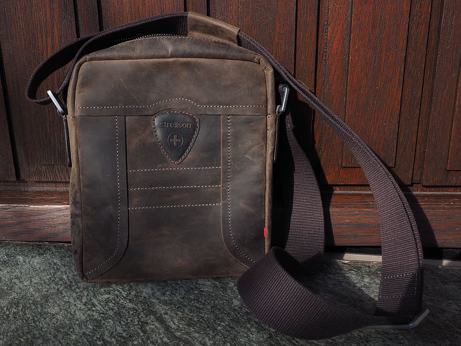 brown leather crossbody bag learning on brown wooden wall, leather case HD wallpaper