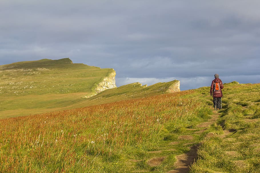 person standing on grass, person standing on green mountain during daytime HD wallpaper