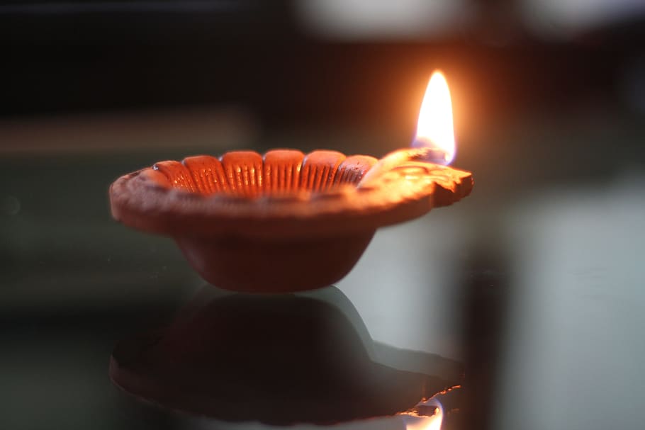 lit candle on brown holder, diwali festival, diwali lamp, diwali greetings