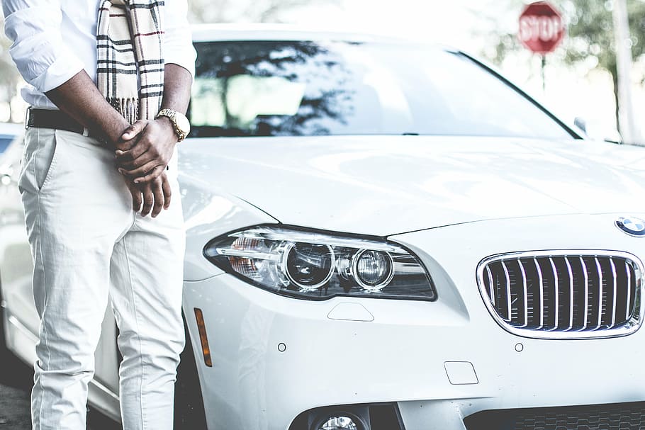 man standing beside white BMW car, guy, headlight, bumper, windshield HD wallpaper