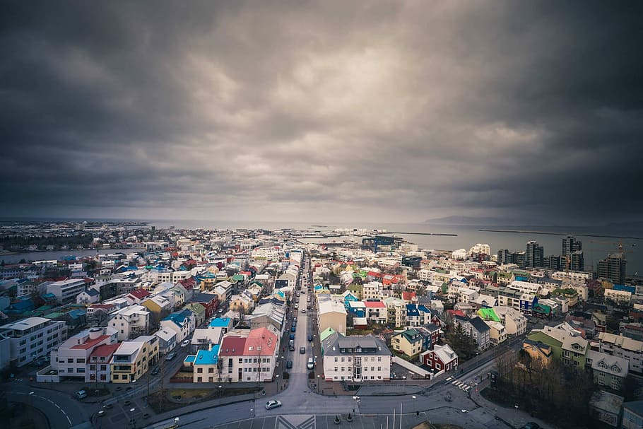landscape photography of buildings, aerial view of town under cloudy skies during daytime