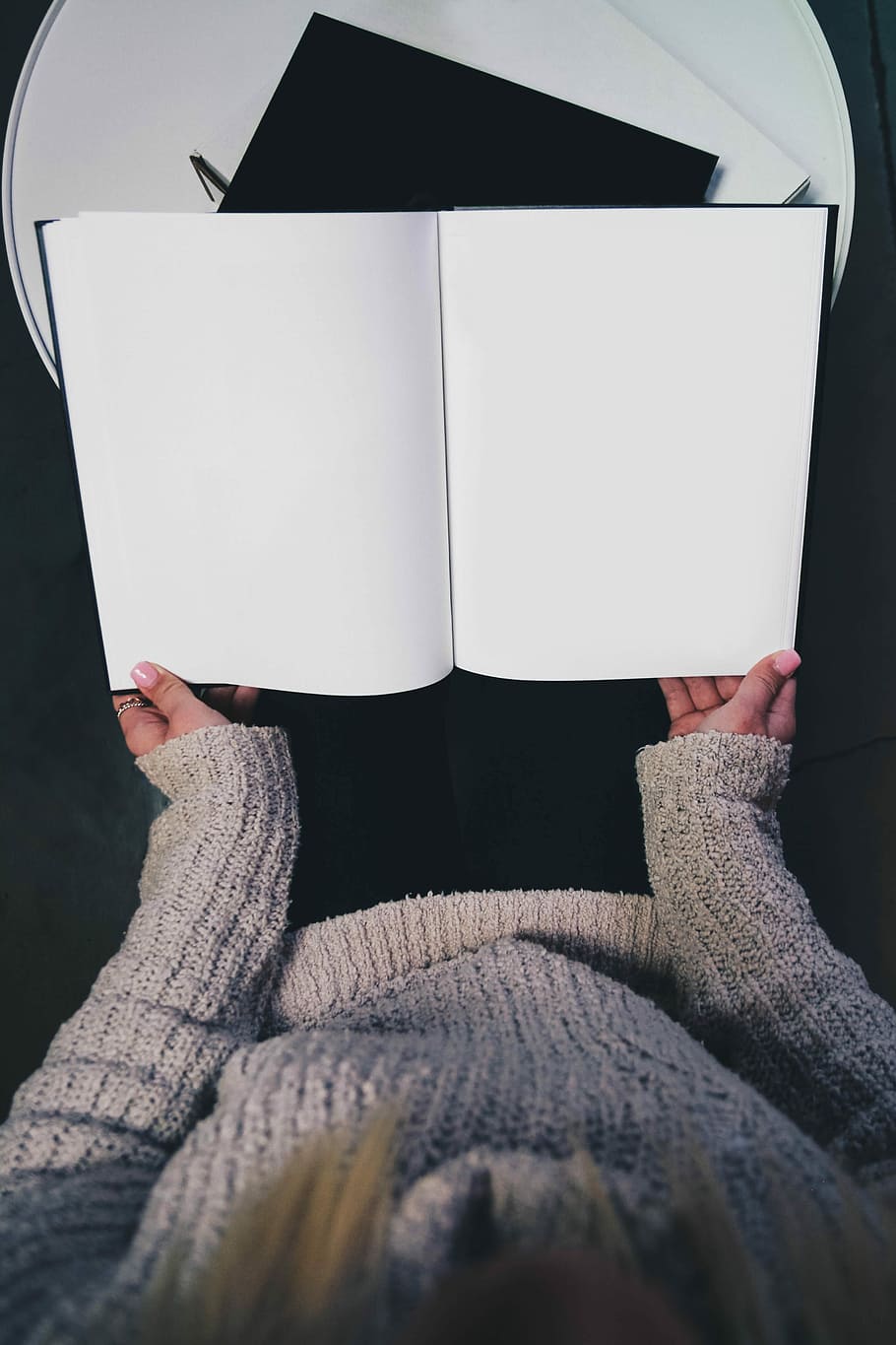 woman wearing sweater opening blank book, woman holding white book HD wallpaper