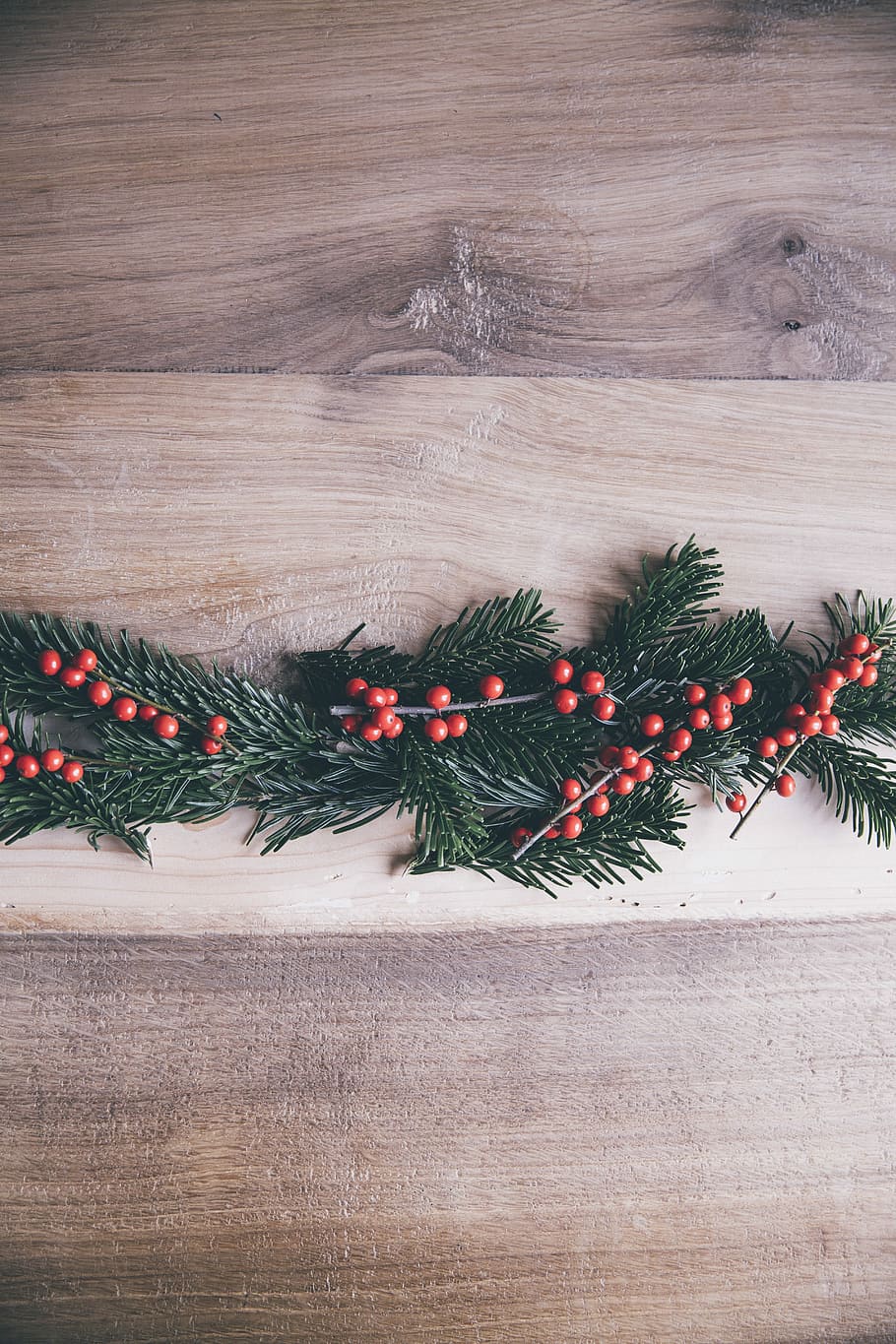 green-and-red Christmas tree leaf on brown floor, red beans near green grass decor HD wallpaper