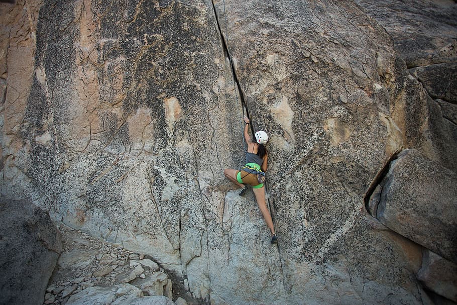 woman climbing on rock formation, equipment, rappelling, adventure