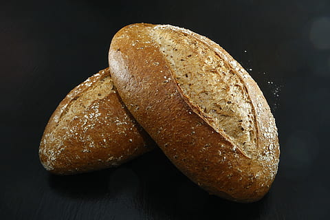 two breads on black surface, baker, craft, food, oven, freshly baked HD wallpaper