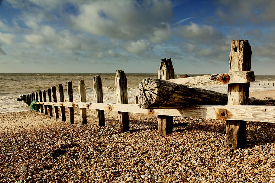 brown wooden fence beside sea, rye, sussex, beach, shore, sand
