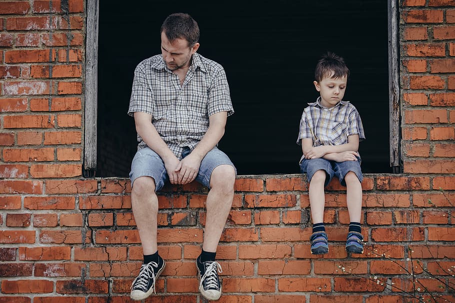 man sitting beside boy on brown bricks window, sad man, sad son HD wallpaper