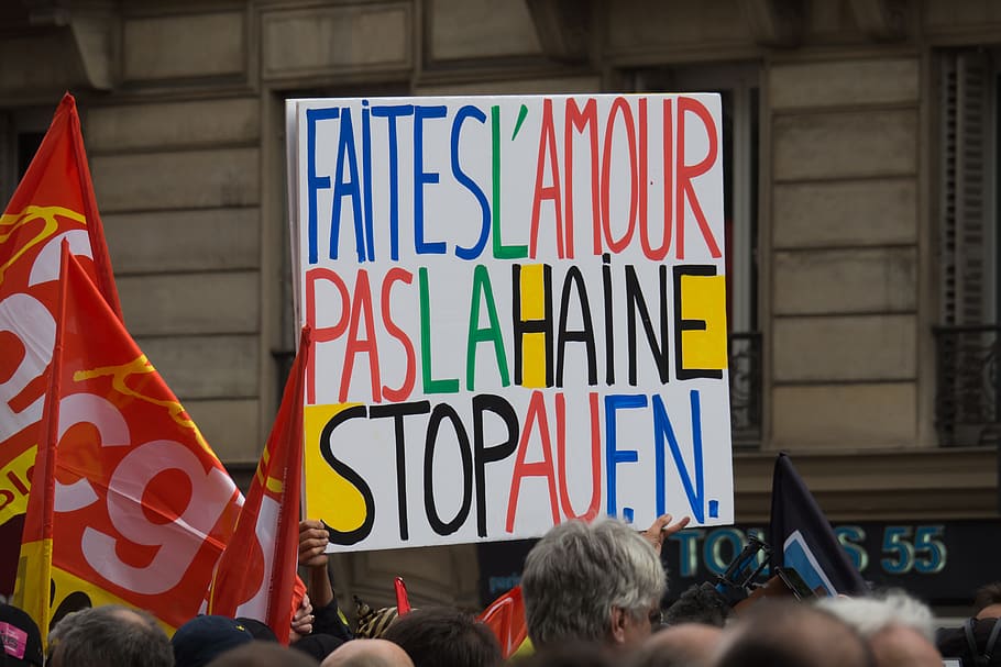 faitesl'amour paaslahaine stopaufn rally signage during daytime, person raising multicolored signboard