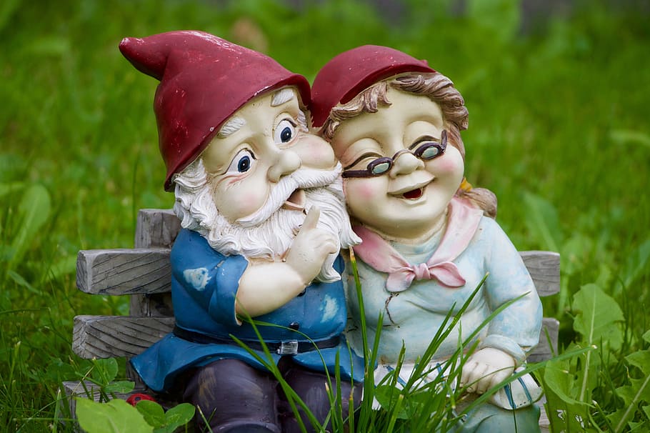 male and female dwarf seating on gray bench chair figurine HD wallpaper