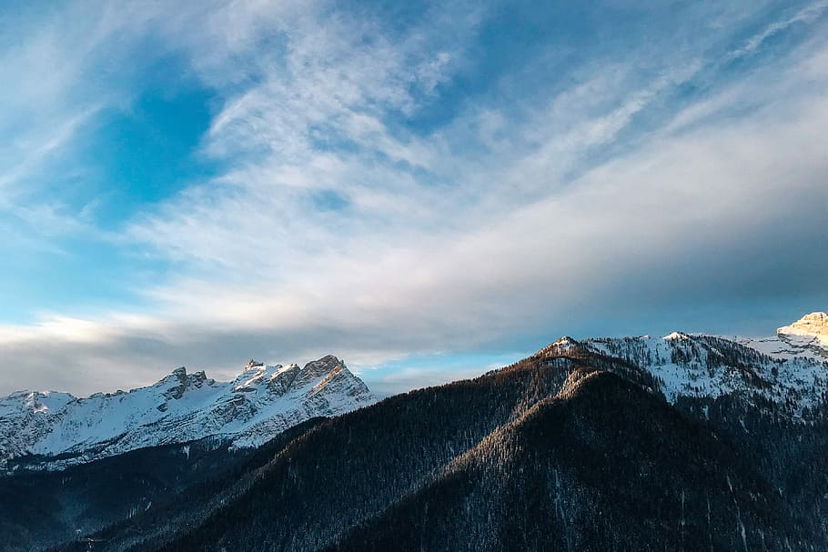 landscape photo of gray mountains covered with snow under cloudy sky during daytime, aerial photo of snow-capped mountain under blue sky and white clouds HD wallpaper