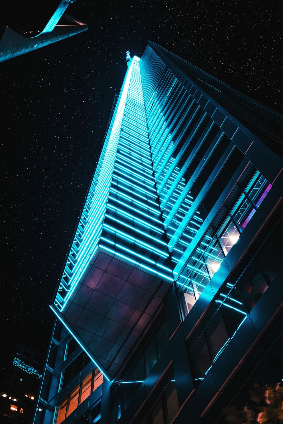 low angle photo of high-rise building, blue and black concrete building during night time photography HD wallpaper