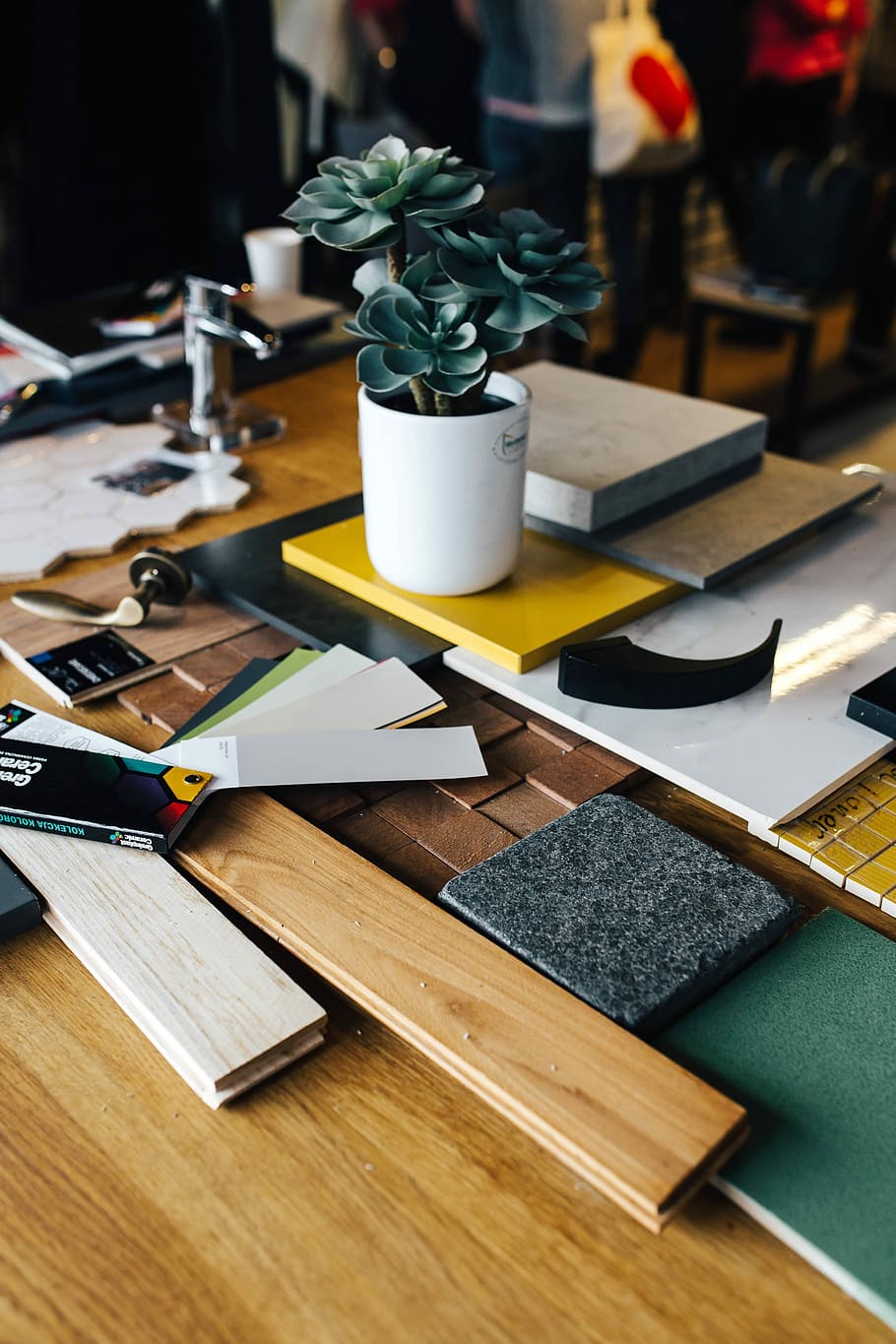 Designers working with material samples and paper cutouts, fabric HD wallpaper
