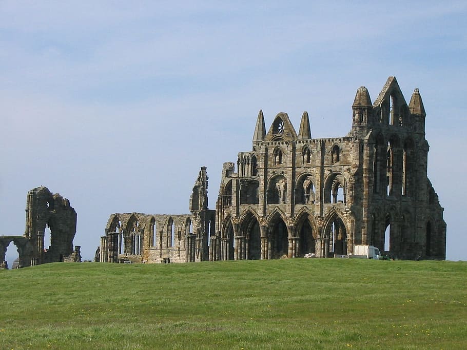 grey concrete ruin mansion on top of green grass field, Whitby, Abbey