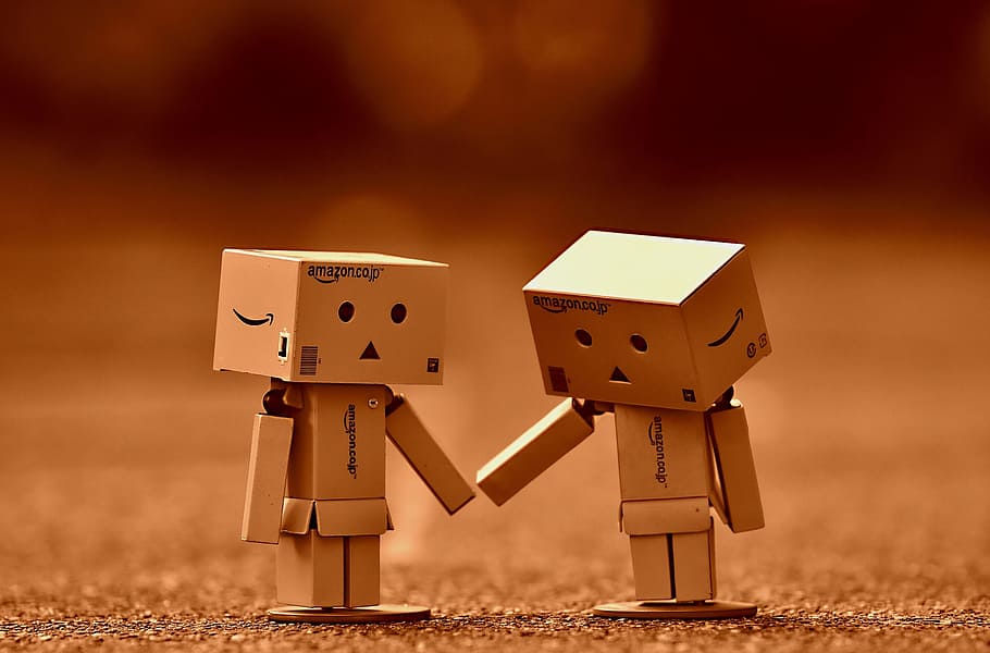 two human cardboard boxes on brown surface, danbo, figure, together