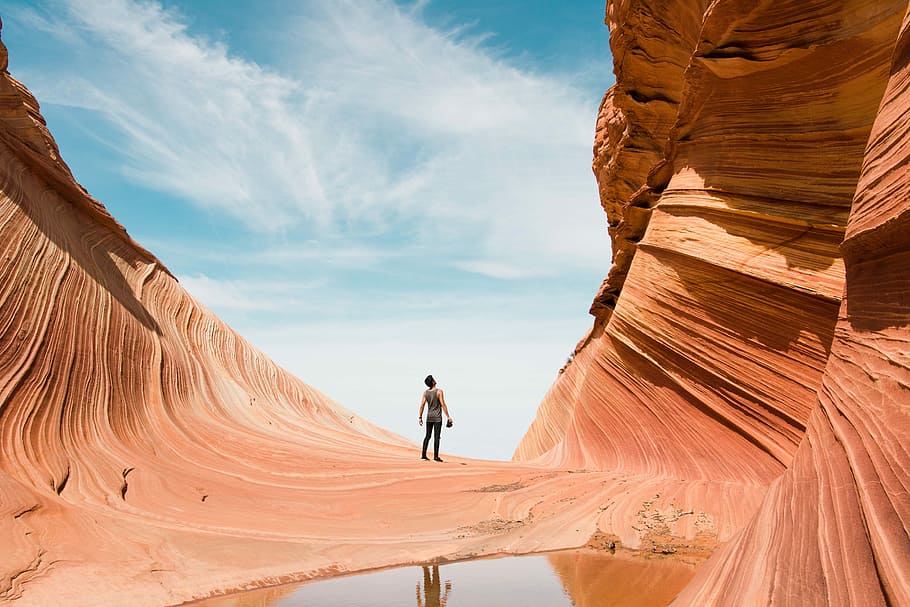 man on antelope canyon during daytime, man standing on brown rock mountain during daytime, HD wallpaper