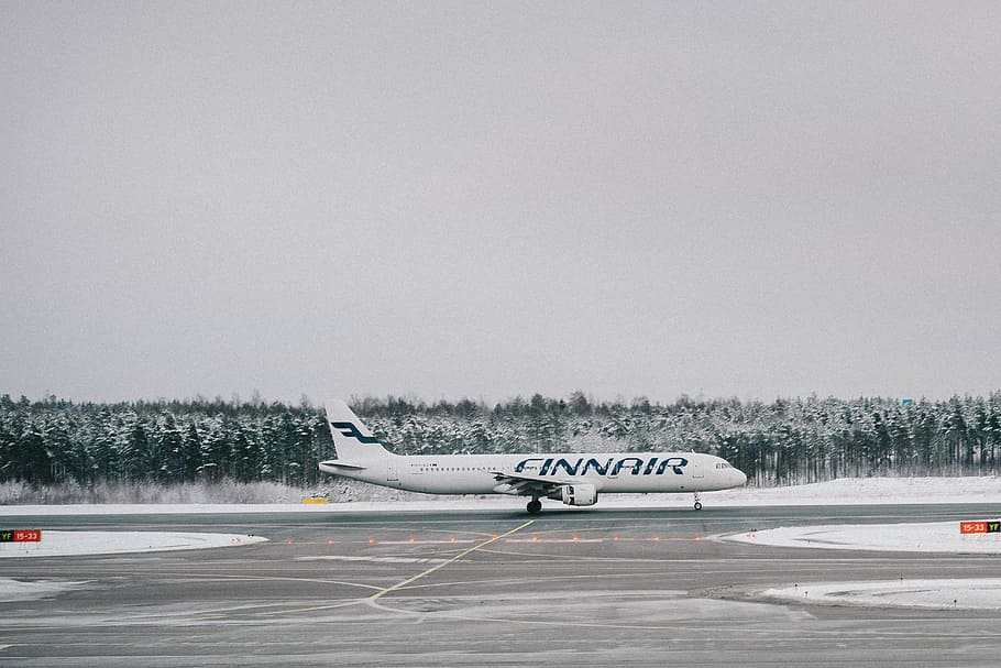 passenger plane on runway, white Finnair of runaway, airplane