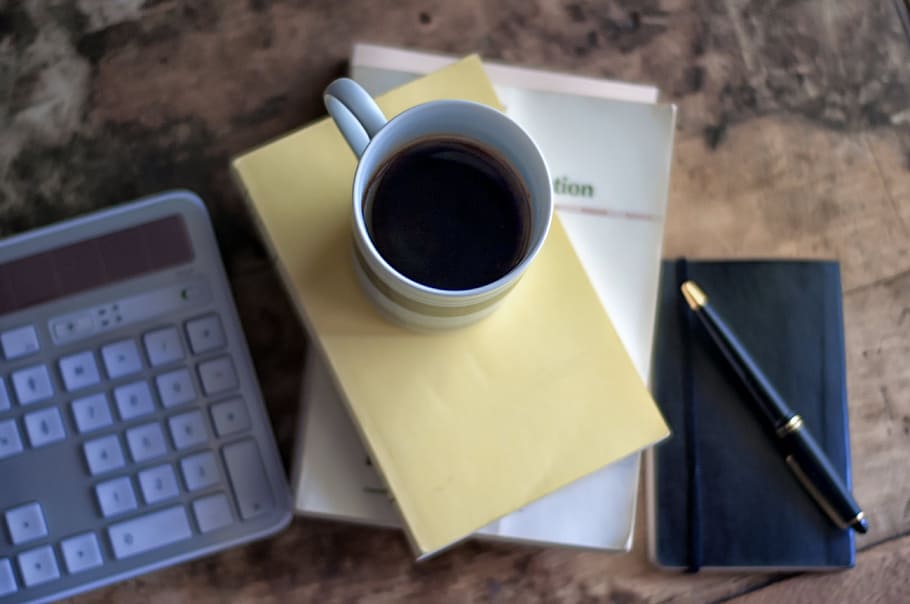 white ceramic cup filled with coffee, coffee mug, pen, notebook HD wallpaper