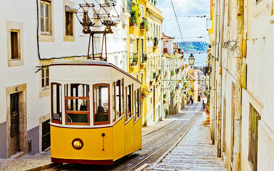 yellow and white train on rails between houses, Lisbon, Landscape
