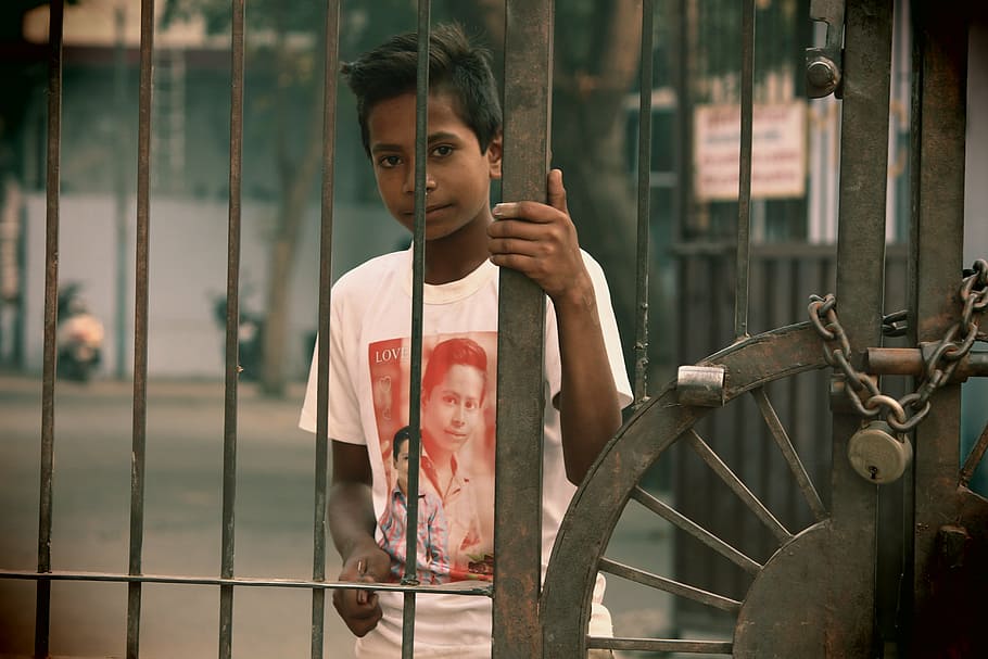 boy holding brown metal gate, poor, young, child, person, asian HD wallpaper