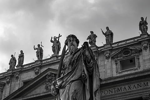 photo of gray concrete statue of man under white clouds at daytime HD wallpaper