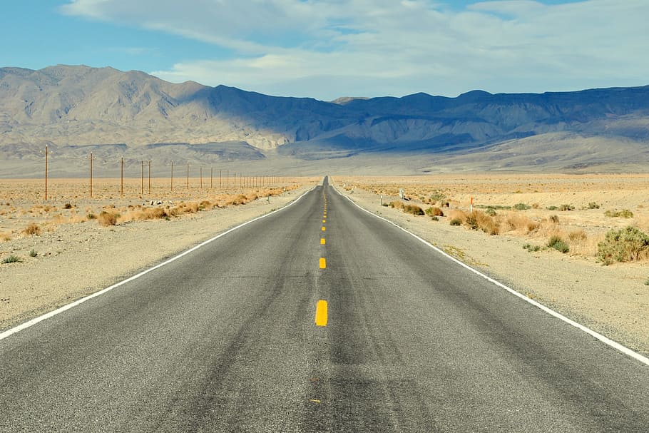 black concrete road near high mountains under blue and white sky at daytime, HD wallpaper