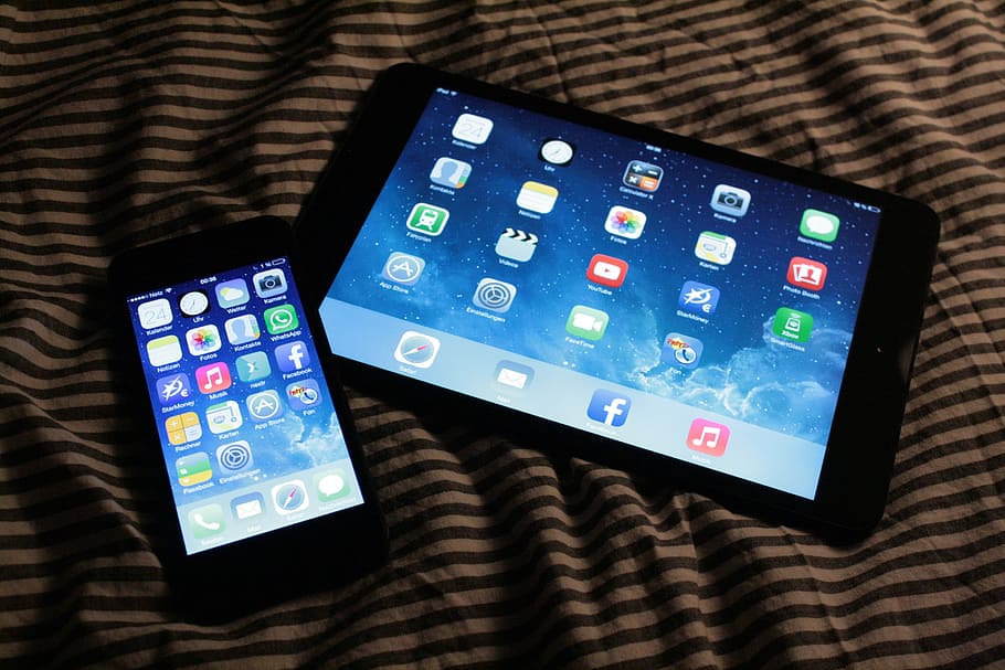 two turned-on black Android smartphone and tablet on textile HD wallpaper