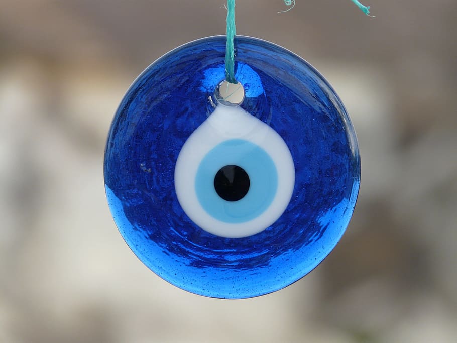 shallow focus photography of evil eye pendant, close up, blue