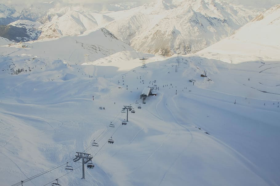 aerial photography of cable car near concrete house at daytime, white snow cable car HD wallpaper