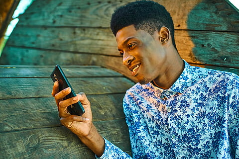 man wearing white and blue dress shirt holding black smartphone HD wallpaper