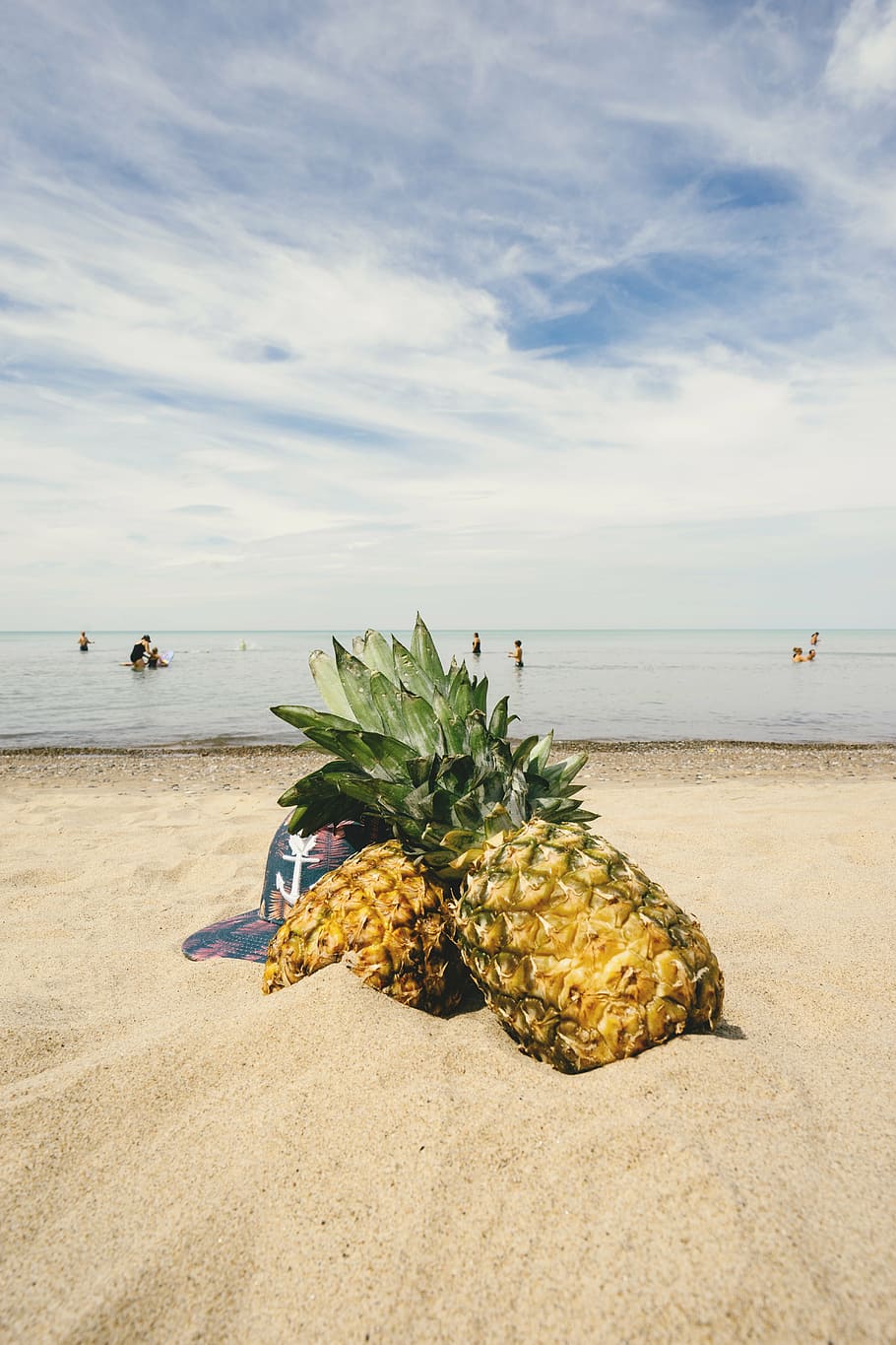 two pineapple fruits in front of seashore, pineapples, sand HD wallpaper