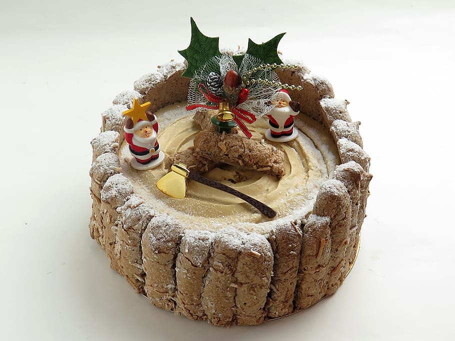 round brown and green Christmas decor on white surface, cake