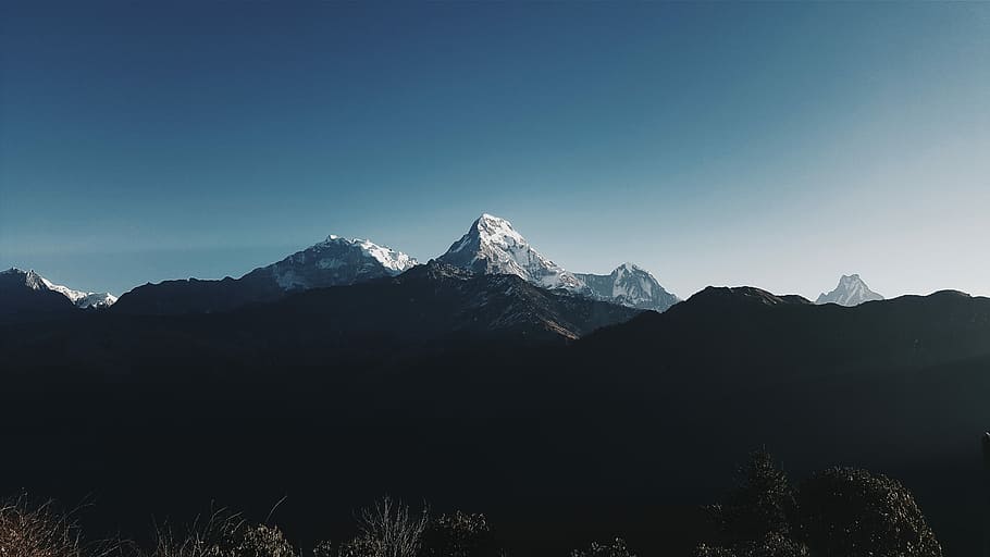 silhouette of mountain with view of snow-capped mountain range during daytime photo, photo of mountain under blue sky background HD wallpaper