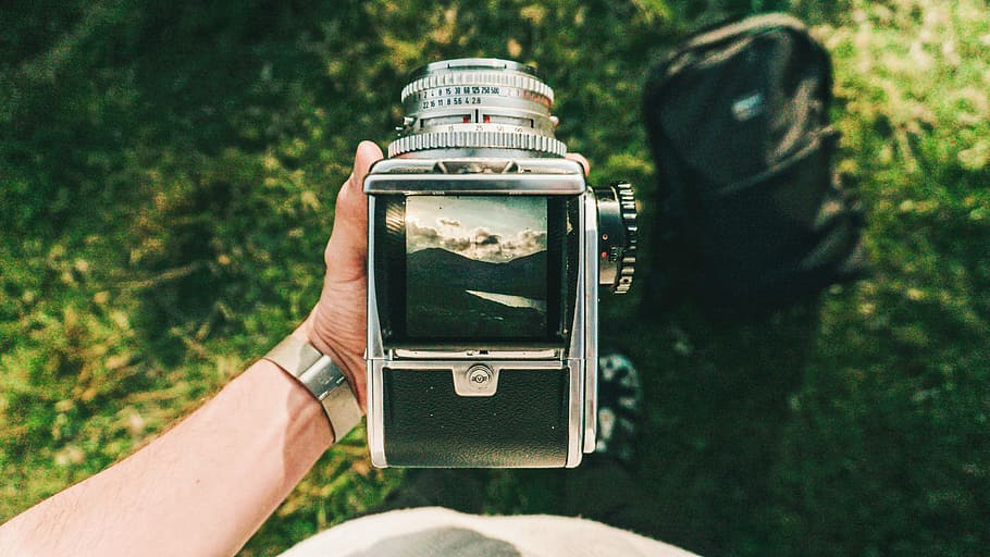 person holding SLR camera showing mountain range, hand, vintage HD wallpaper
