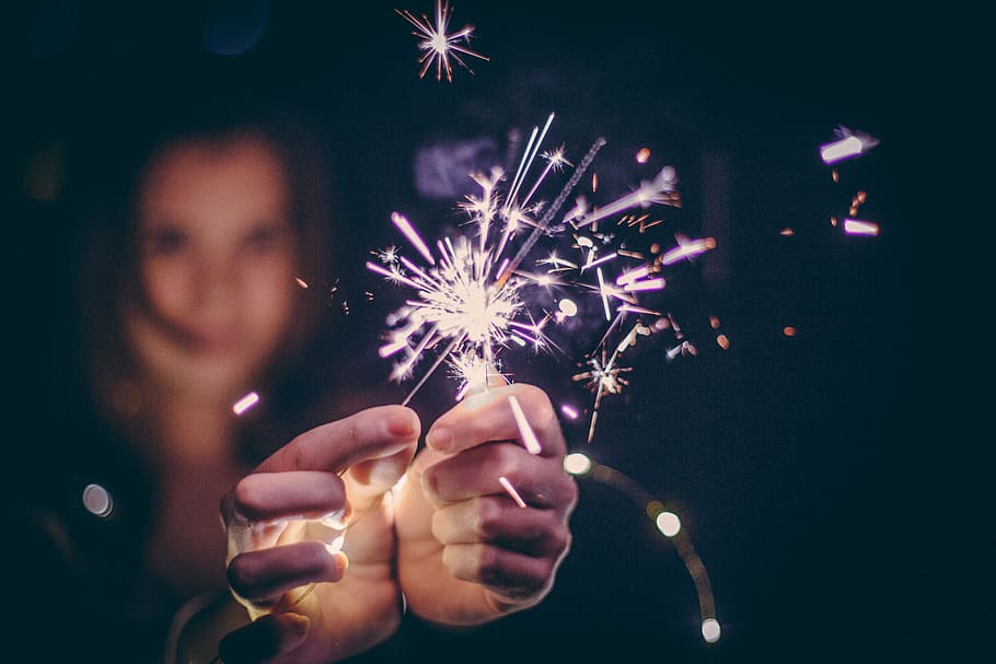 person holding sparkling sparkler, hand, sparklers, firework HD wallpaper