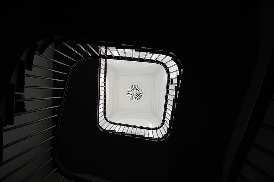 gray spiral case, low angle photography of swirl stairway, staircase