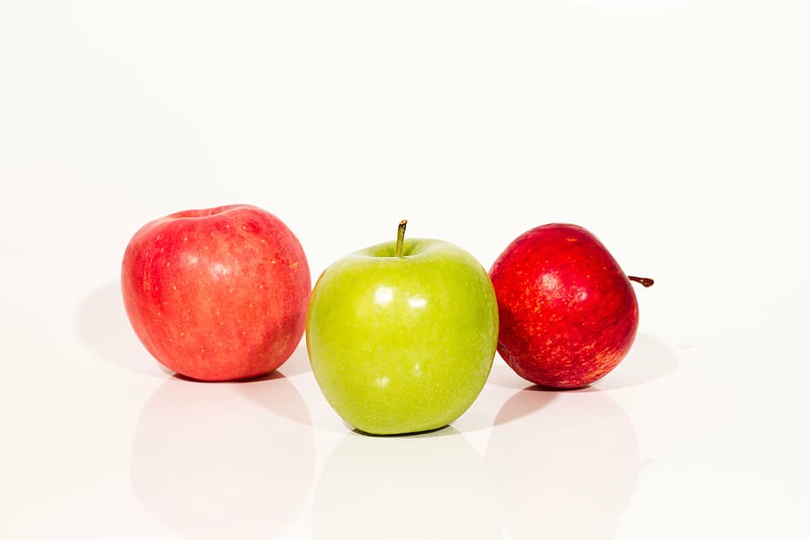 two red and one green apples on white surface, fruit, apple - fruit HD wallpaper